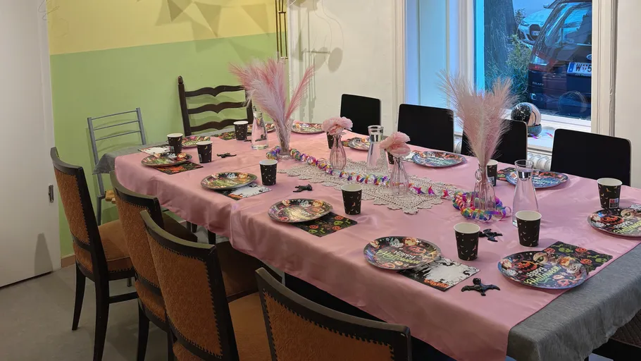 Dining table decorated for a party with chairs.