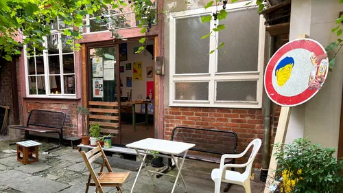 Outdoor café with chairs and plants.