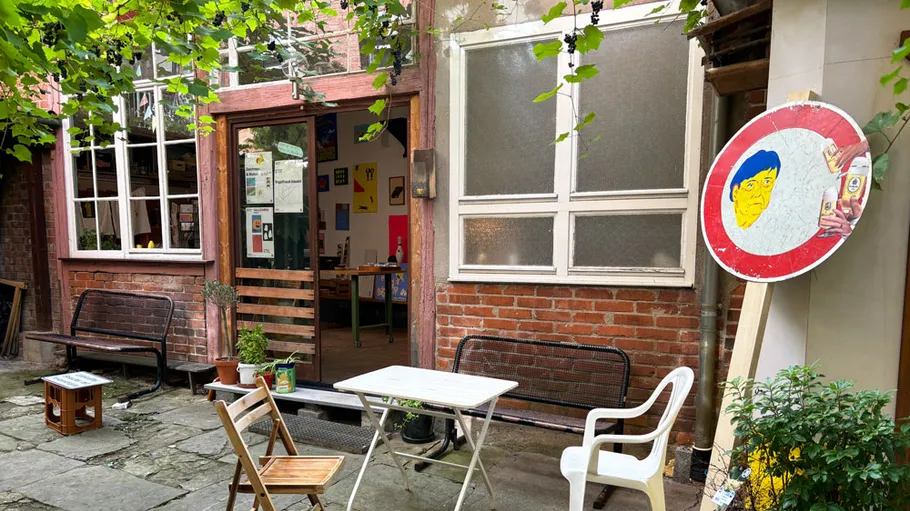 Outdoor café with chairs and plants.