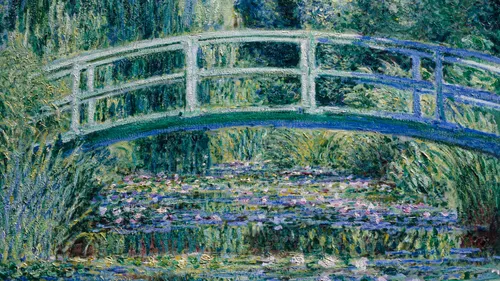Bridge over a pond with water lilies.