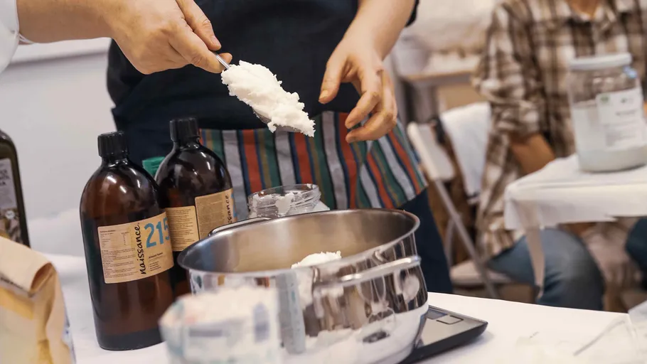 Person measuring ingredients in a kitchen setting.