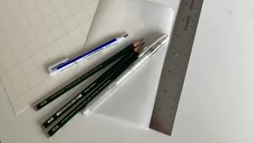 Pencils and ruler on drawing paper.
