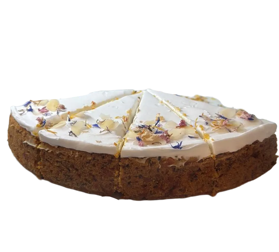 Sliced cake with white icing and flowers.