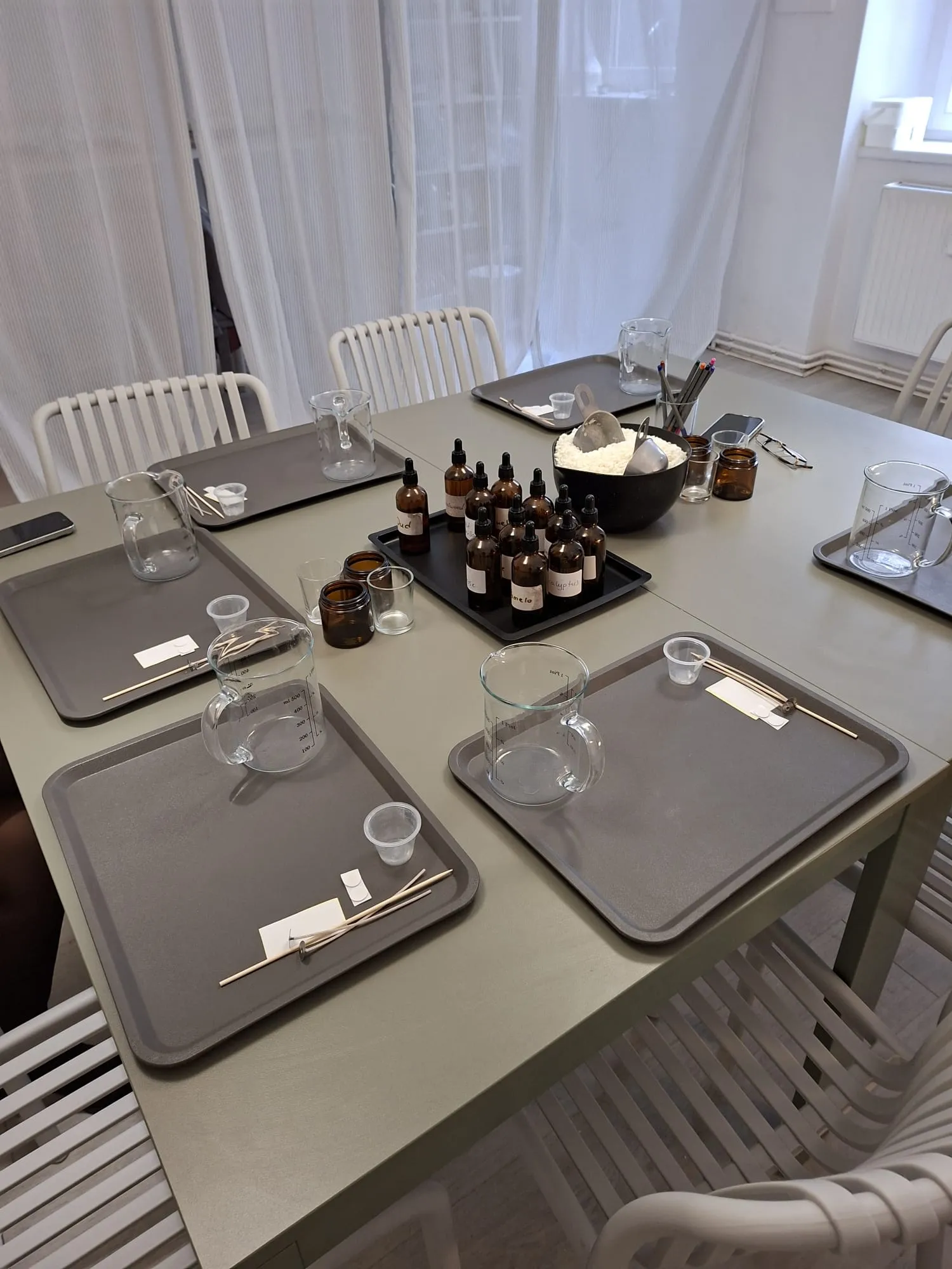 Tisch mit Tabletts, Flaschen und Messbechern.