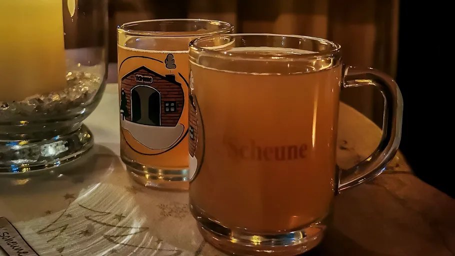Two mugs of warm drink on a table.