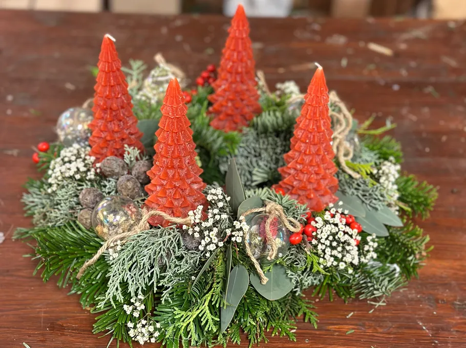 Red candles on festive green wreath.