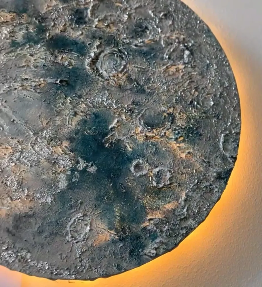Textured moon sculpture with glowing backlight.