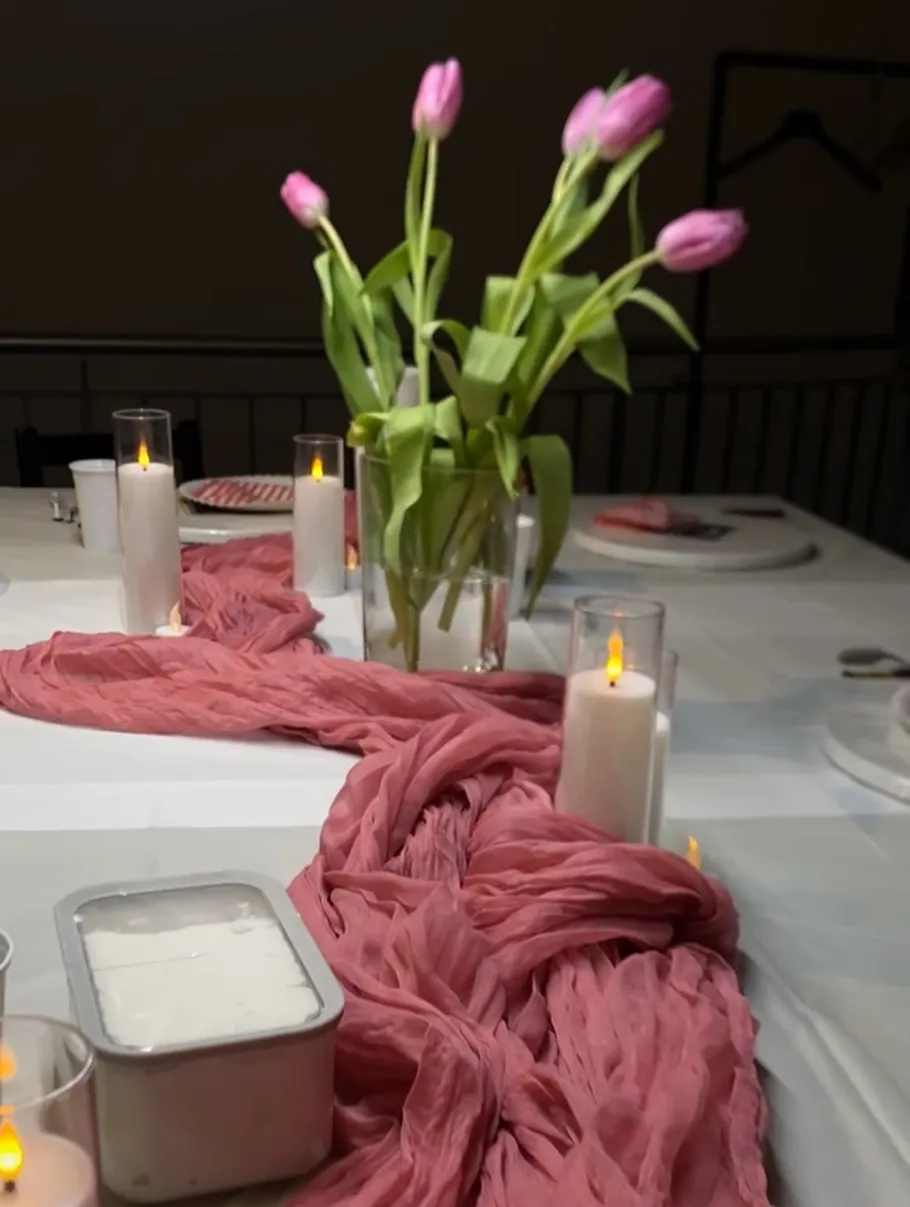 Pink tulips on elegantly set dining table.