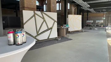Canvas with geometric patterns in industrial studio.