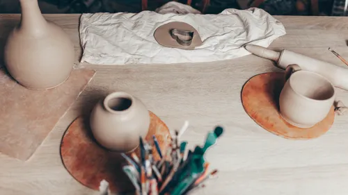 Clay pottery tools and creations on table.