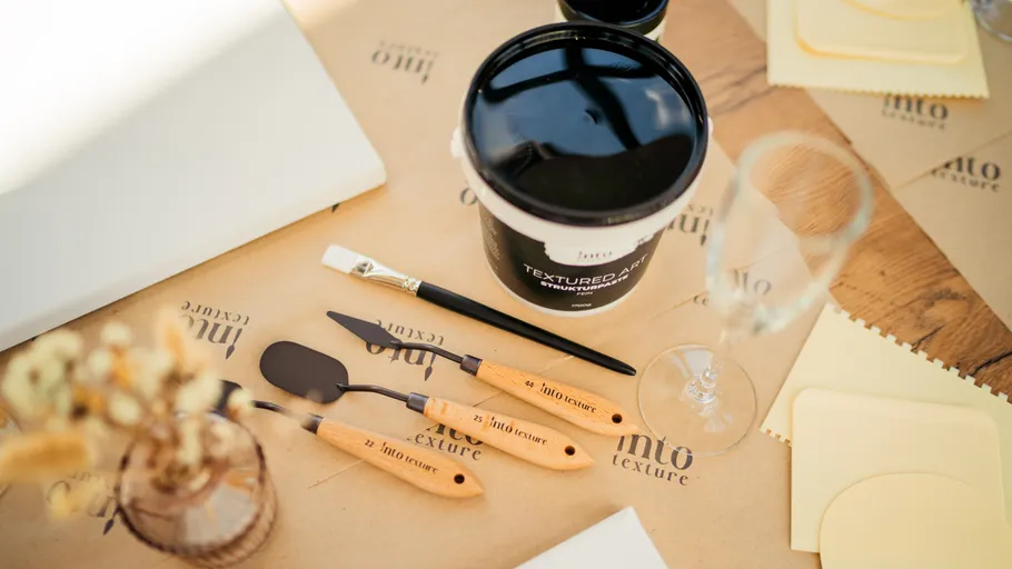 Art supplies on a wooden table.