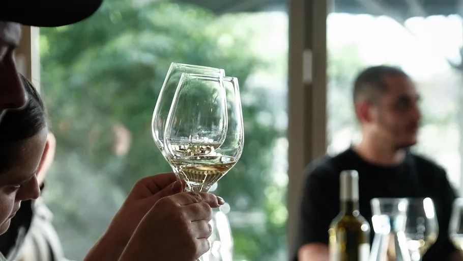 Person examining wine glass in restaurant.