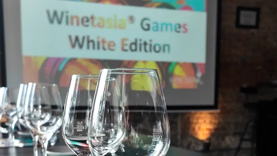Wine glasses on table, blurred conference background.