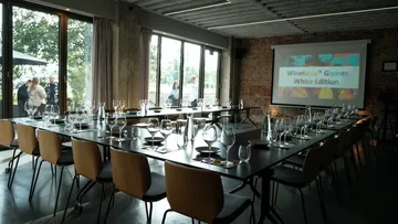 Empty dining room setup with a projector screen.