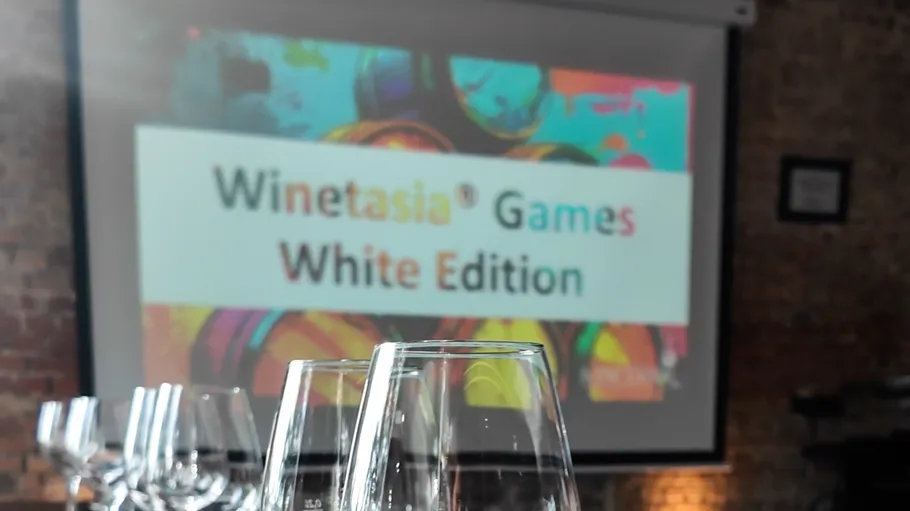 Wine glasses with event screen in background.