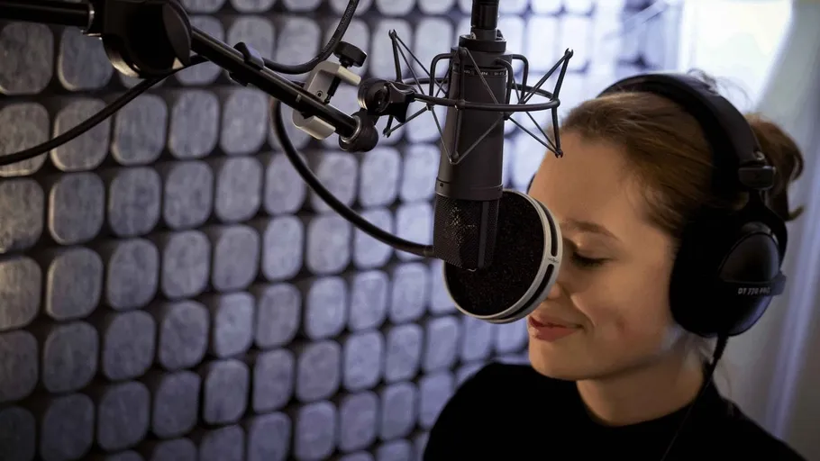 Woman recording in professional sound studio.