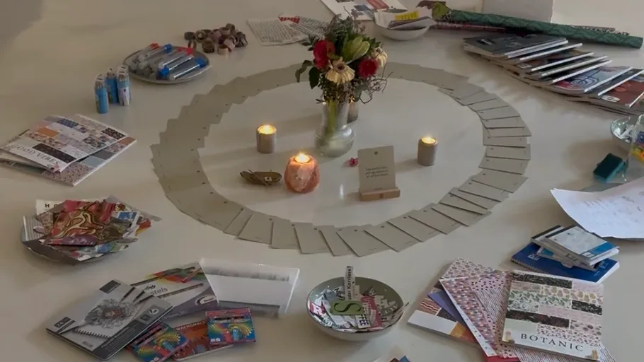 Cards, candles, flowers on a circular arrangement.