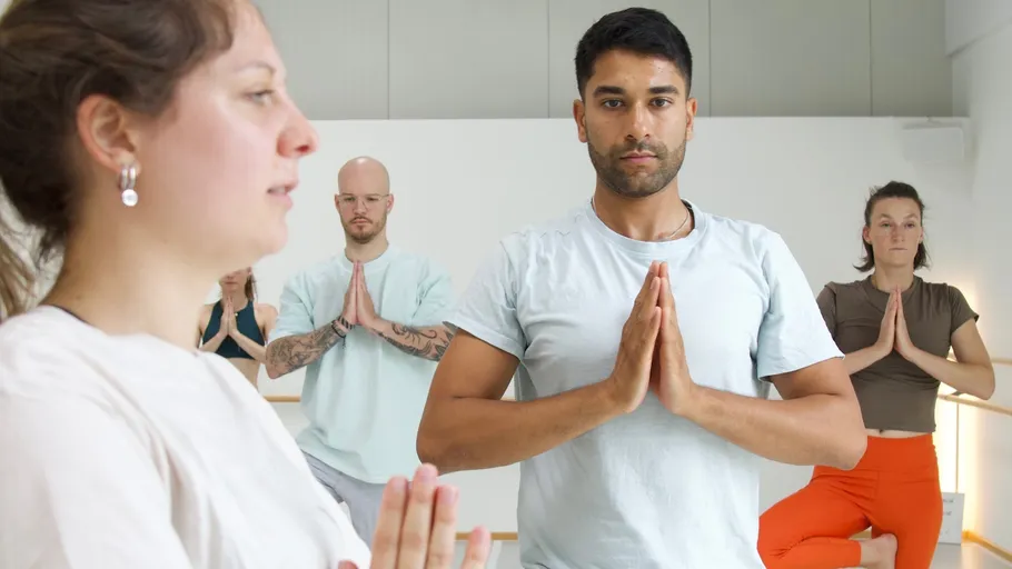 Group practicing yoga in a studio.