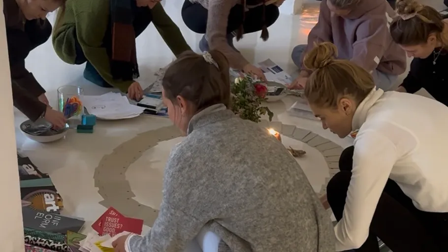 People crafting together on circle floor mat.