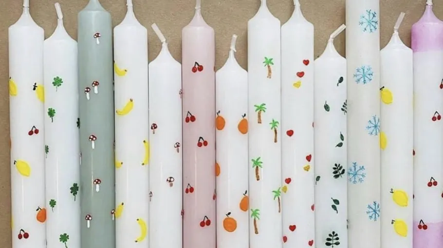 Decorative candles with various small designs.