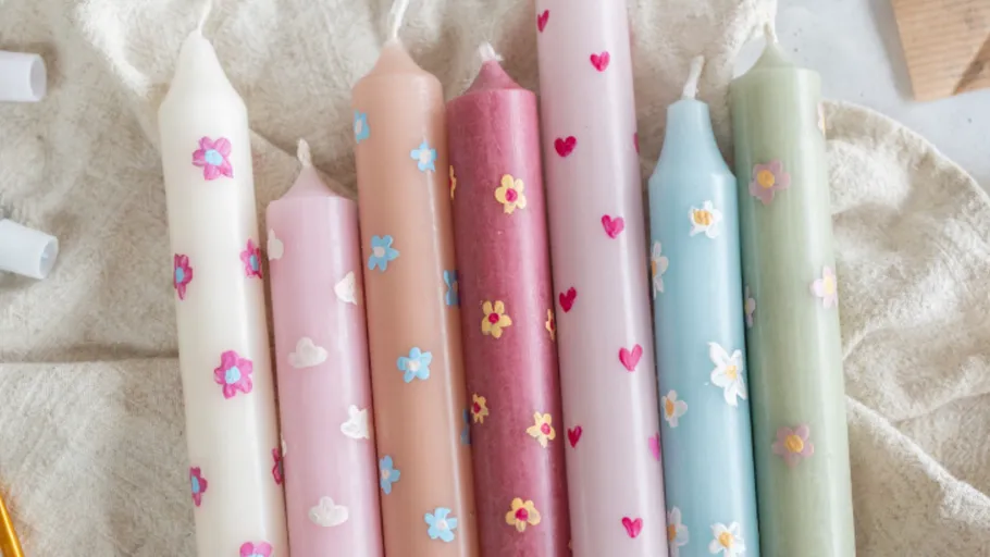 Colorful decorative candles with floral designs.