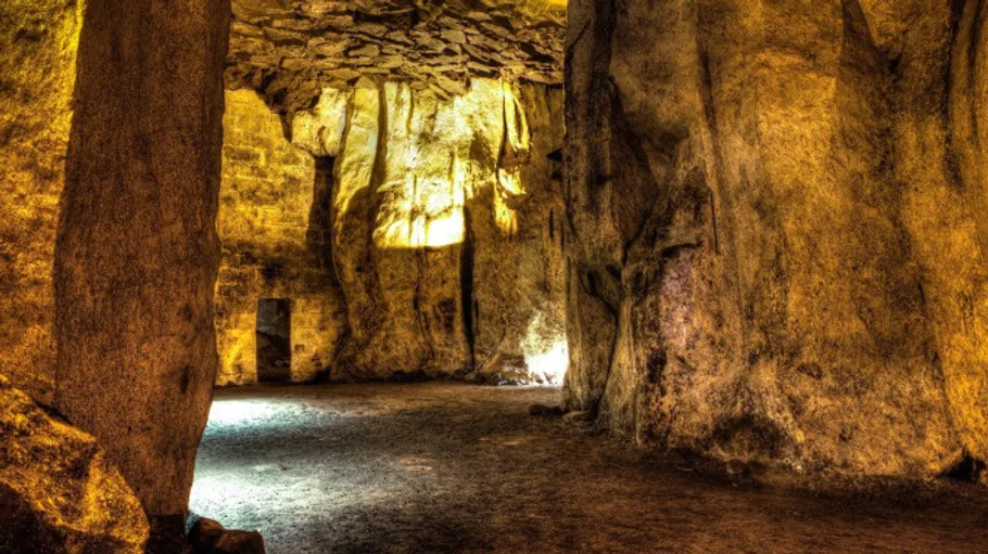 Illuminated cave with rocky walls and floor.
