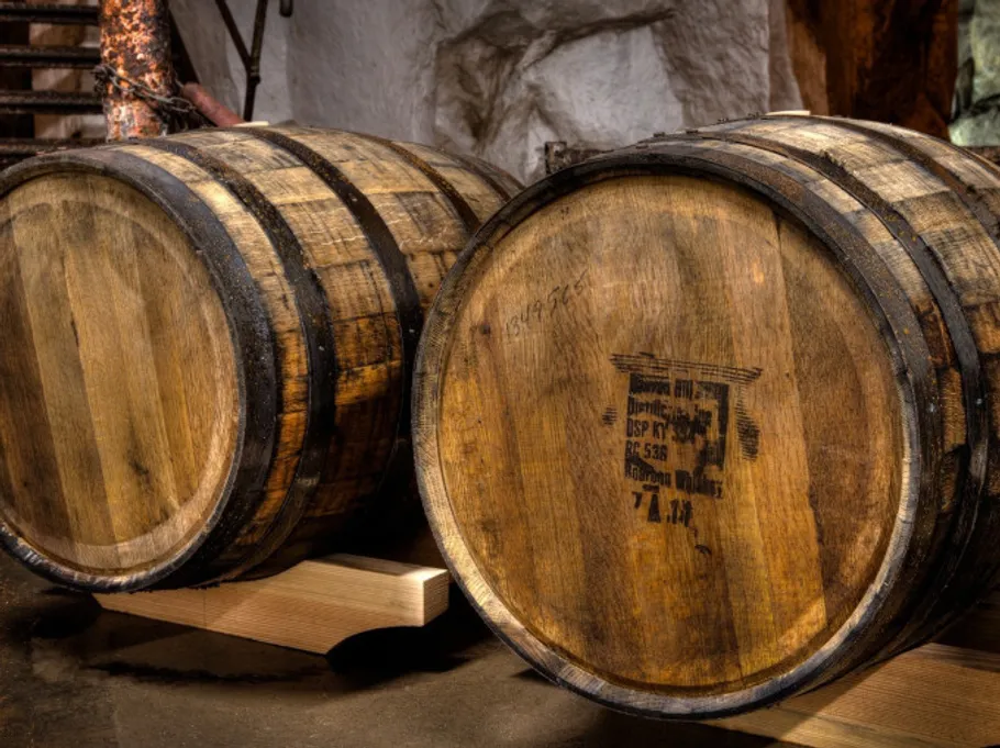 Wooden barrels stored in a cellar.