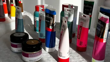 Acrylic paint and jars on a table.