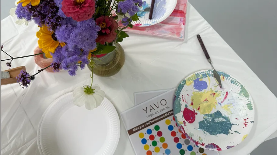 Flowers and painting supplies on a table.
