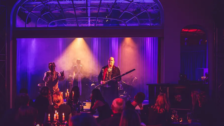 Stage performance with musicians and audience.