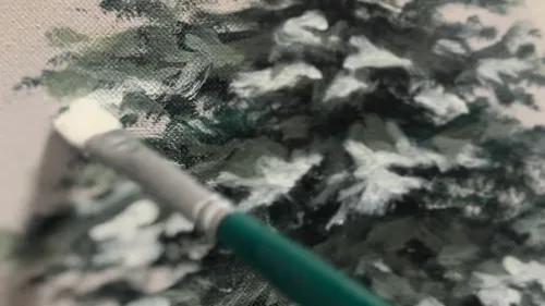 Brush painting snowy trees on canvas.