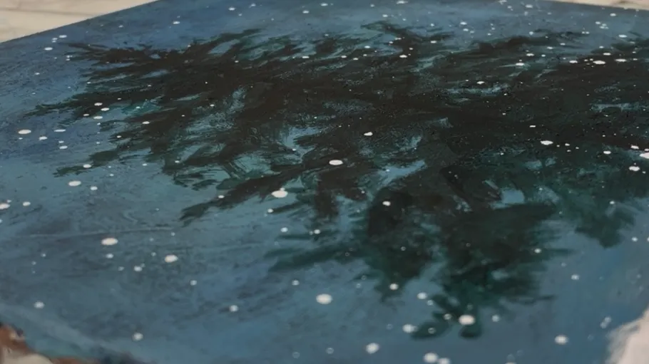 Starry night sky painting with trees.