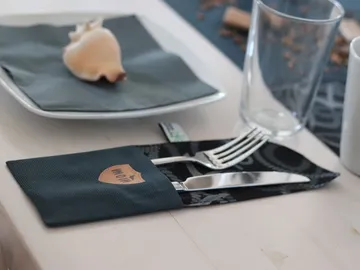 Plate with cutlery on a table with decoration.