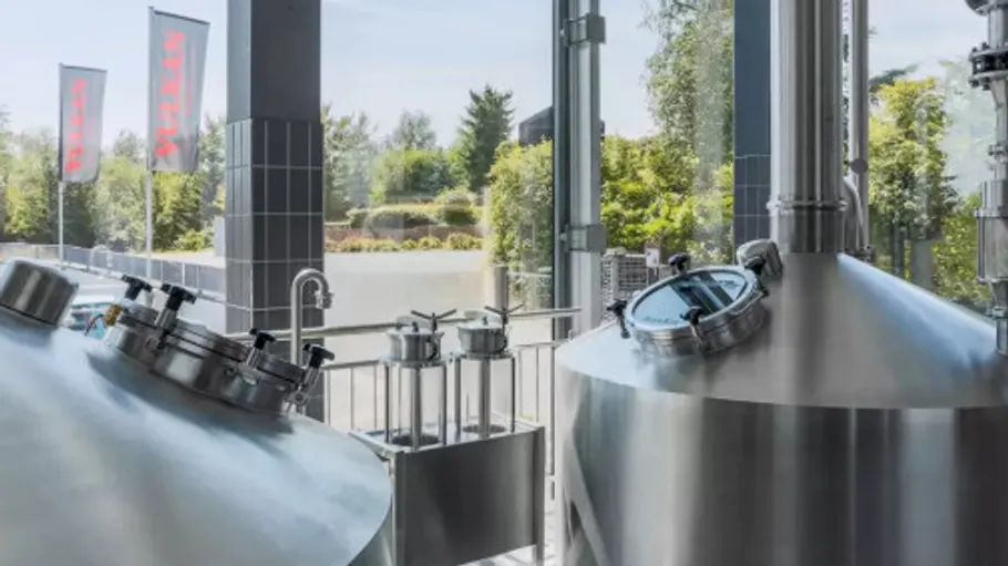 Stainless steel tanks in a brewery setting.