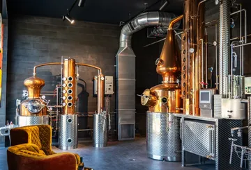 Copper distillation equipment in modern distillery.