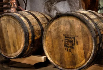 Two wooden barrels in a cellar.