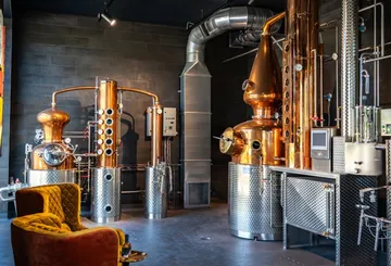 Industrial distillery equipment in a modern room.