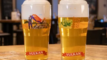 Two beer glasses on a table.