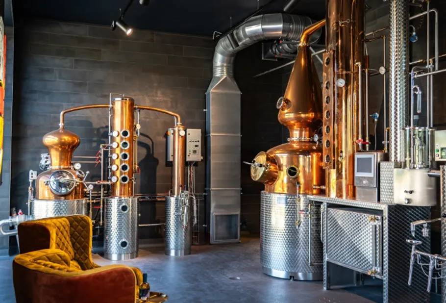 Distillery equipment in an industrial room.