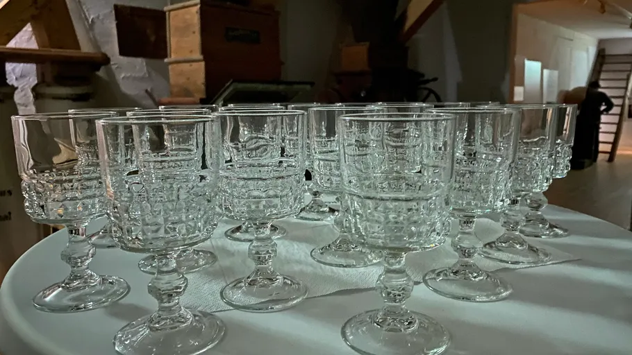 Several glass goblets on a round table.