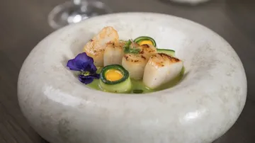 Scallops served in elegant stone bowl.