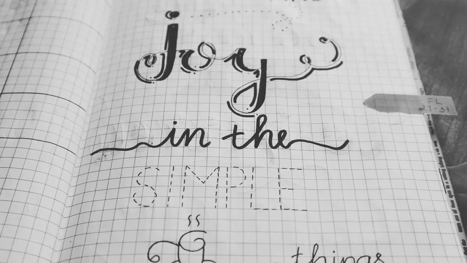 Notebook with handwritten text 'joy in the simple.'