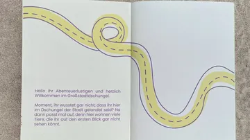 Open booklet with text and winding path.