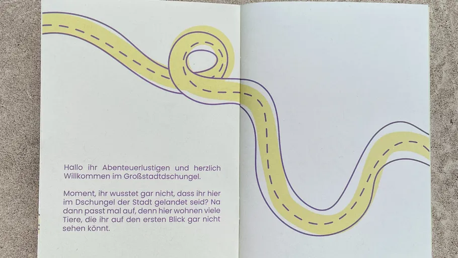Open booklet with text and winding path.