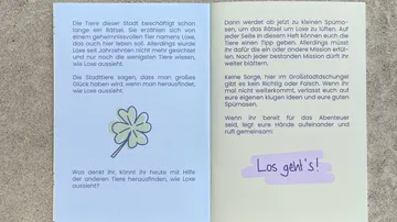 Open book with text and a clover image.