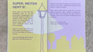 Booklet pages with text and streetlamp illustration.