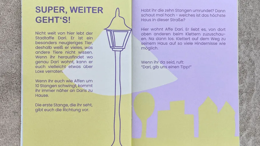 Booklet pages with text and streetlamp illustration.