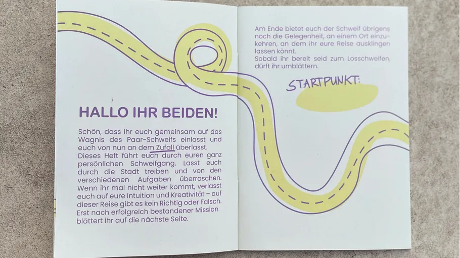 Open book with German text and winding road.