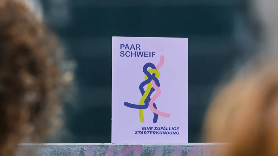 Book cover with abstract design, outdoors.