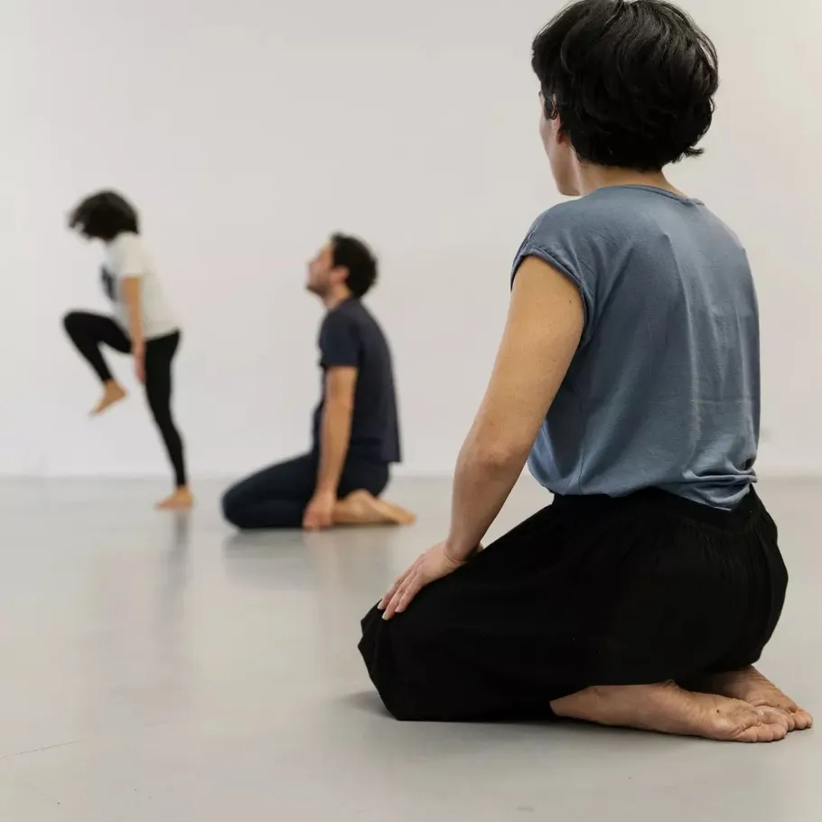People practicing meditation in a studio.